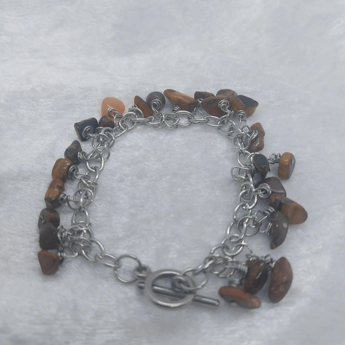Tigers Eye chip bracelet, 8in long, with polished brown and gold stones on a stainless steel chain.