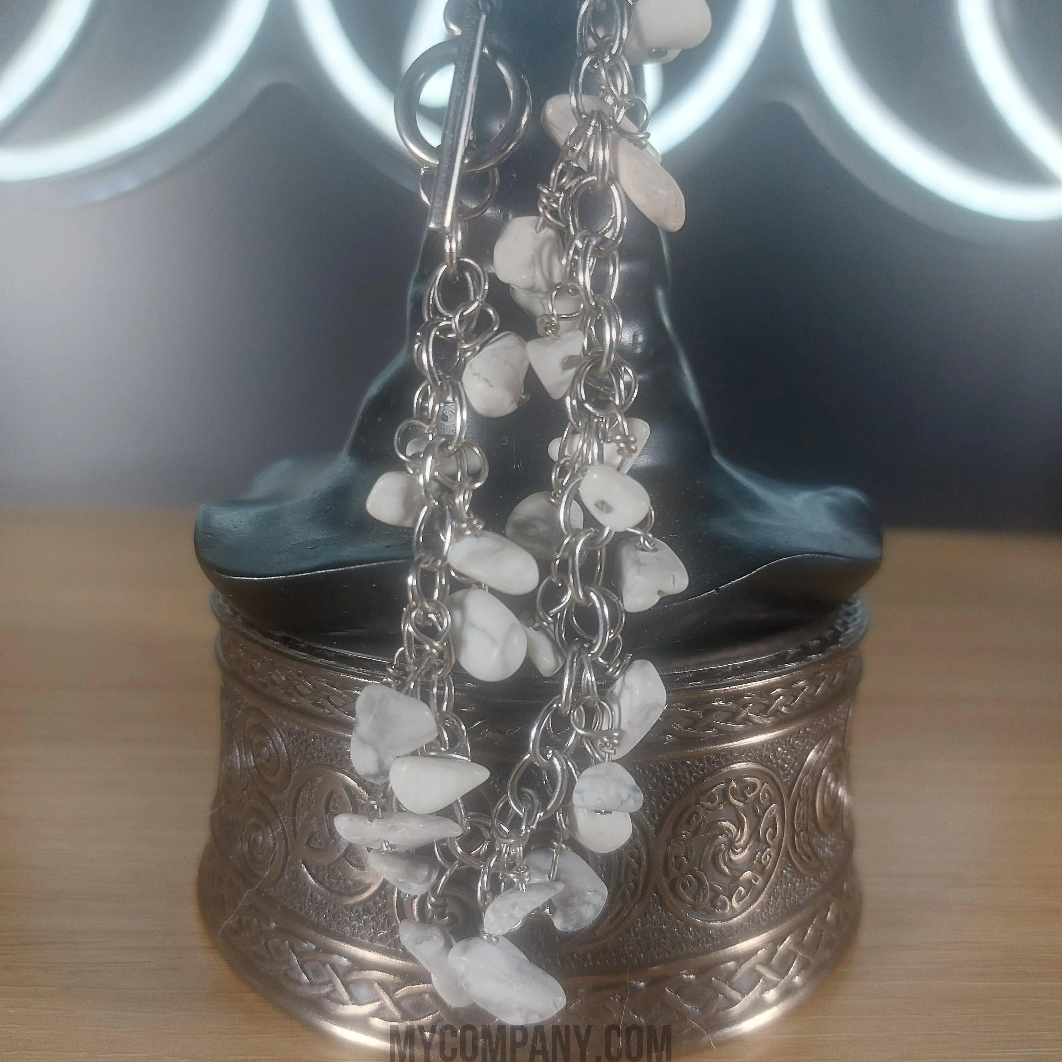 Silver stainless steel dangle charm bracelet with white howlite gemstone chips.