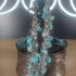 Silver stainless steel chain bracelet with turquoise gemstone chip dangle charms.