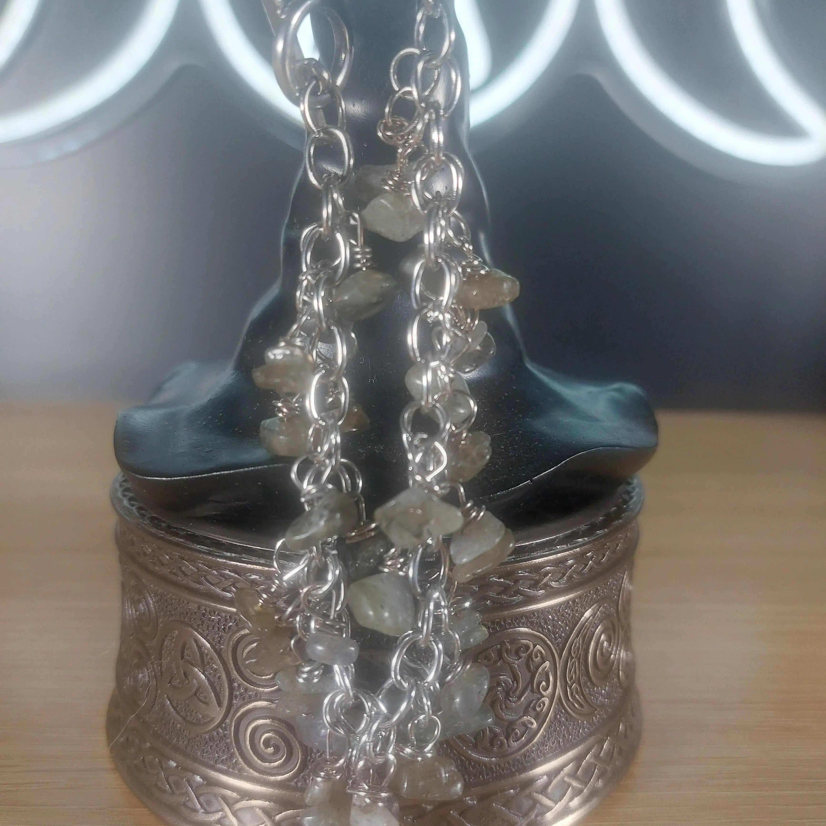 Labradorite chip bracelet with silver chain and clasp, displayed on a decorative box.