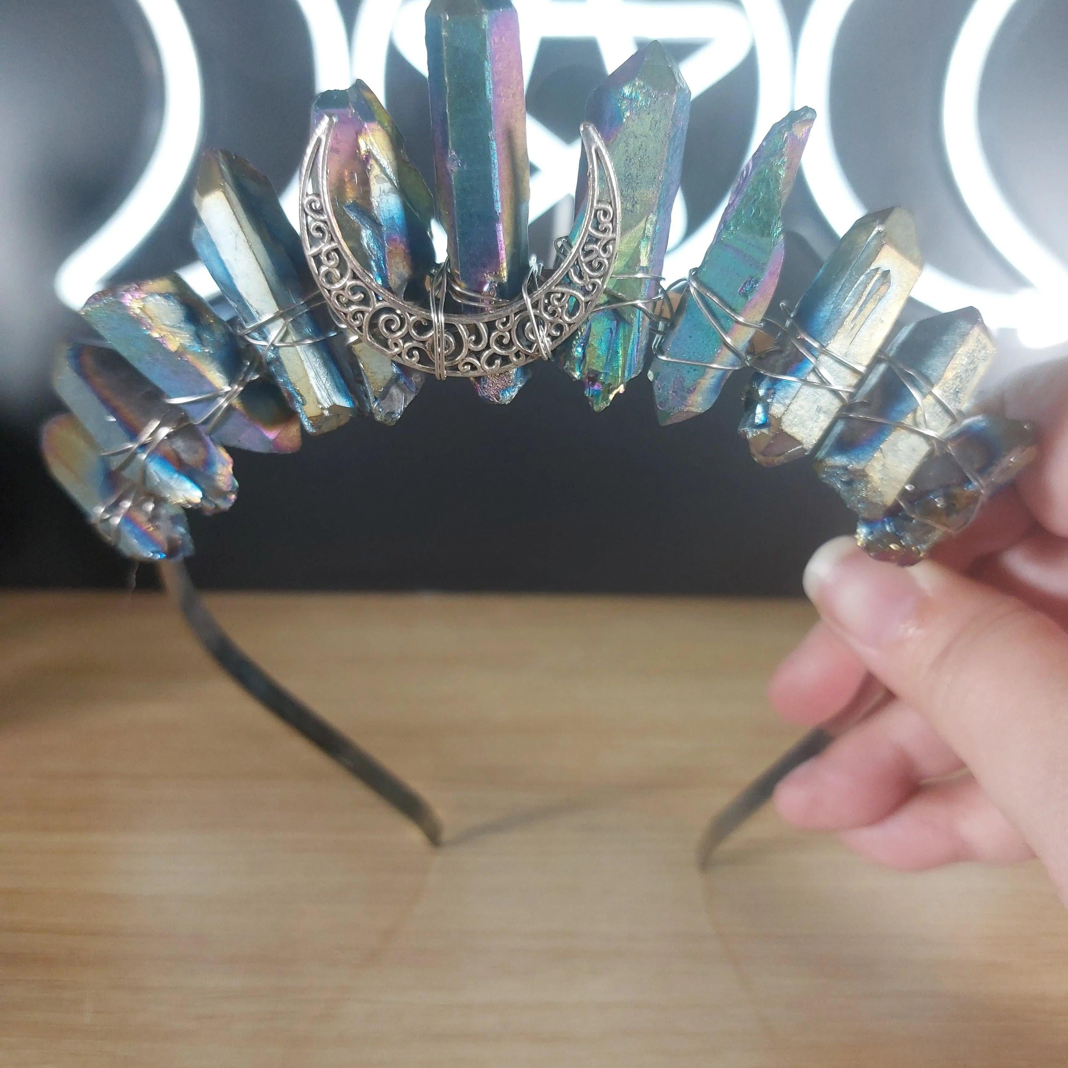Metallic rainbow quartz crystal crown headband with a silver crescent moon accent.