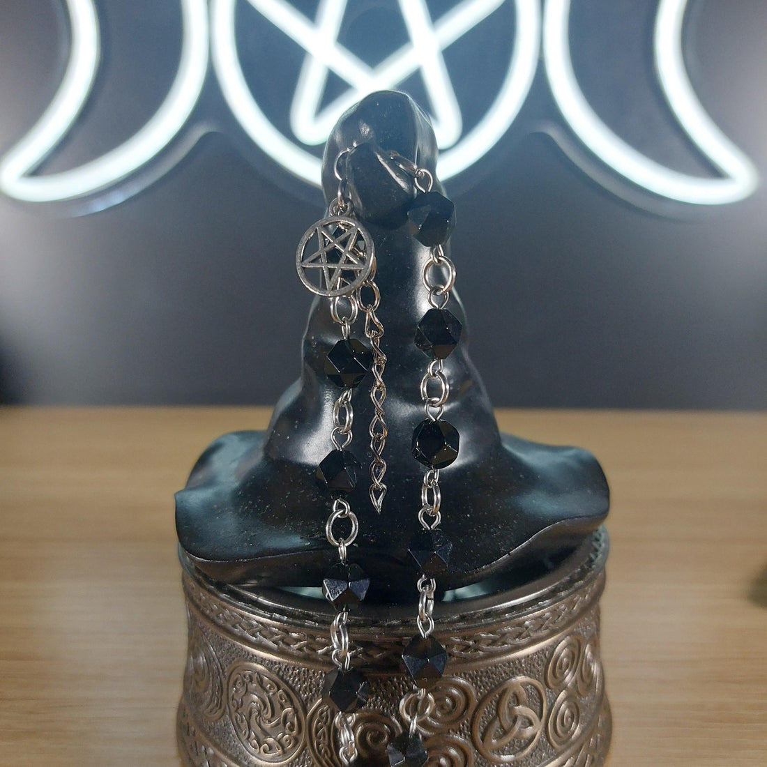 Black onyx faceted crystal bracelet with silver pentagram charm and stainless steel findings.