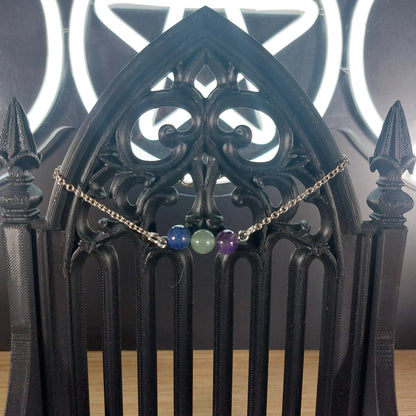 Aquarius Power Stones Bracelet with blue Lapis Lazuli, green Aventurine, and purple Amethyst beads on a silver chain.