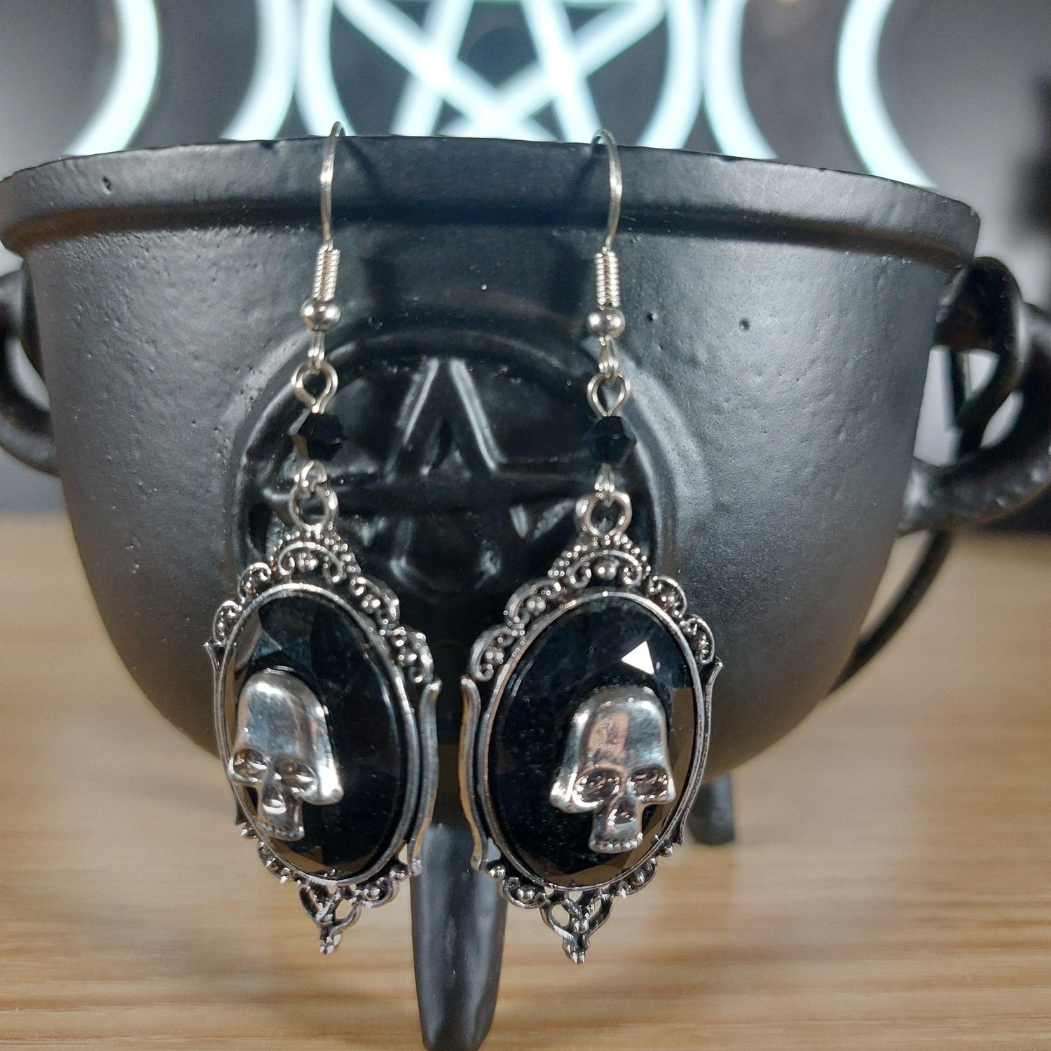 Victorian silver tone skull on black dangle earrings, featuring ornate frames.