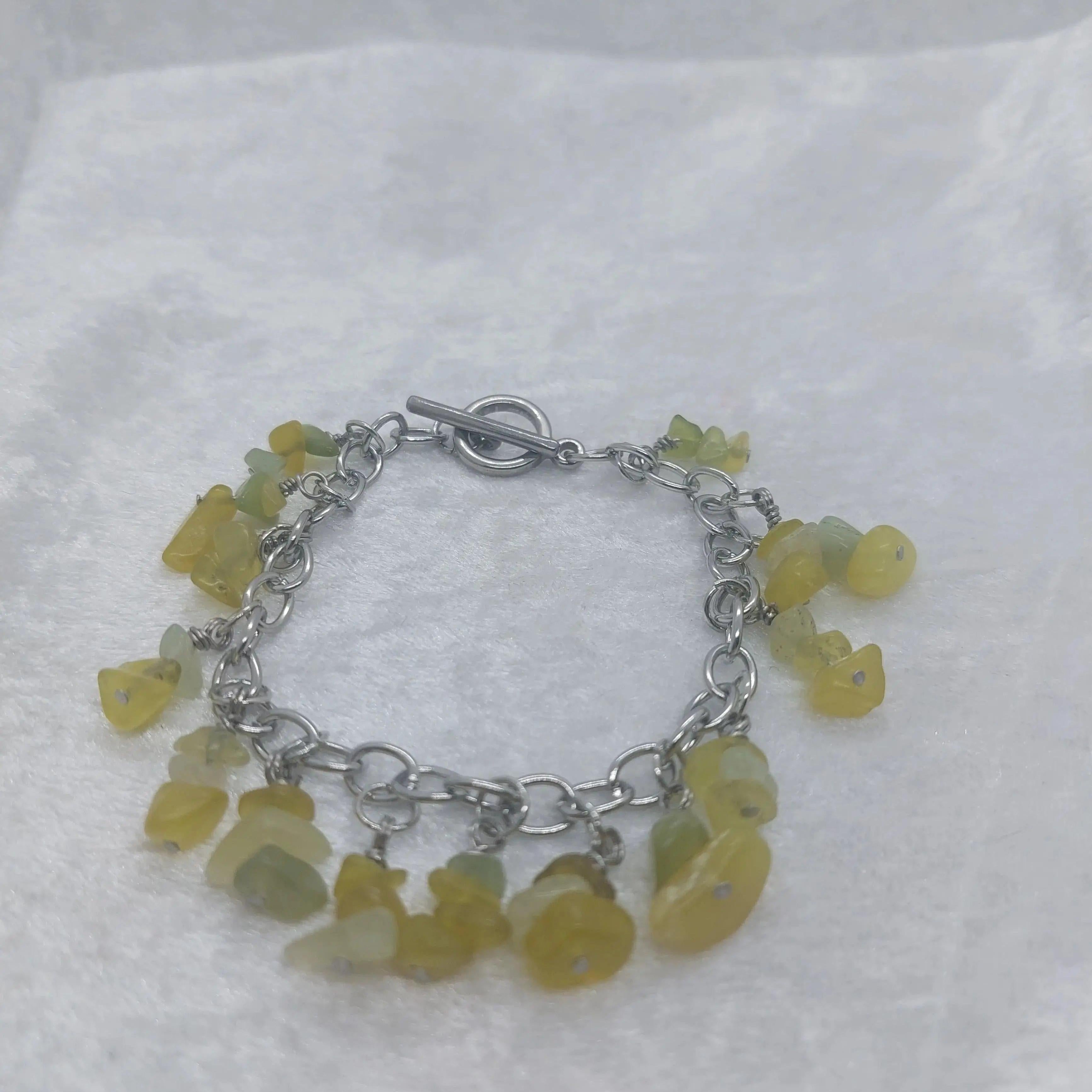 Aventurine chip bracelet with green and yellow stones on a stainless steel chain and toggle clasp.