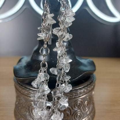 Clear quartz chip bracelet on stainless steel chain, displayed on a dark witch hat.