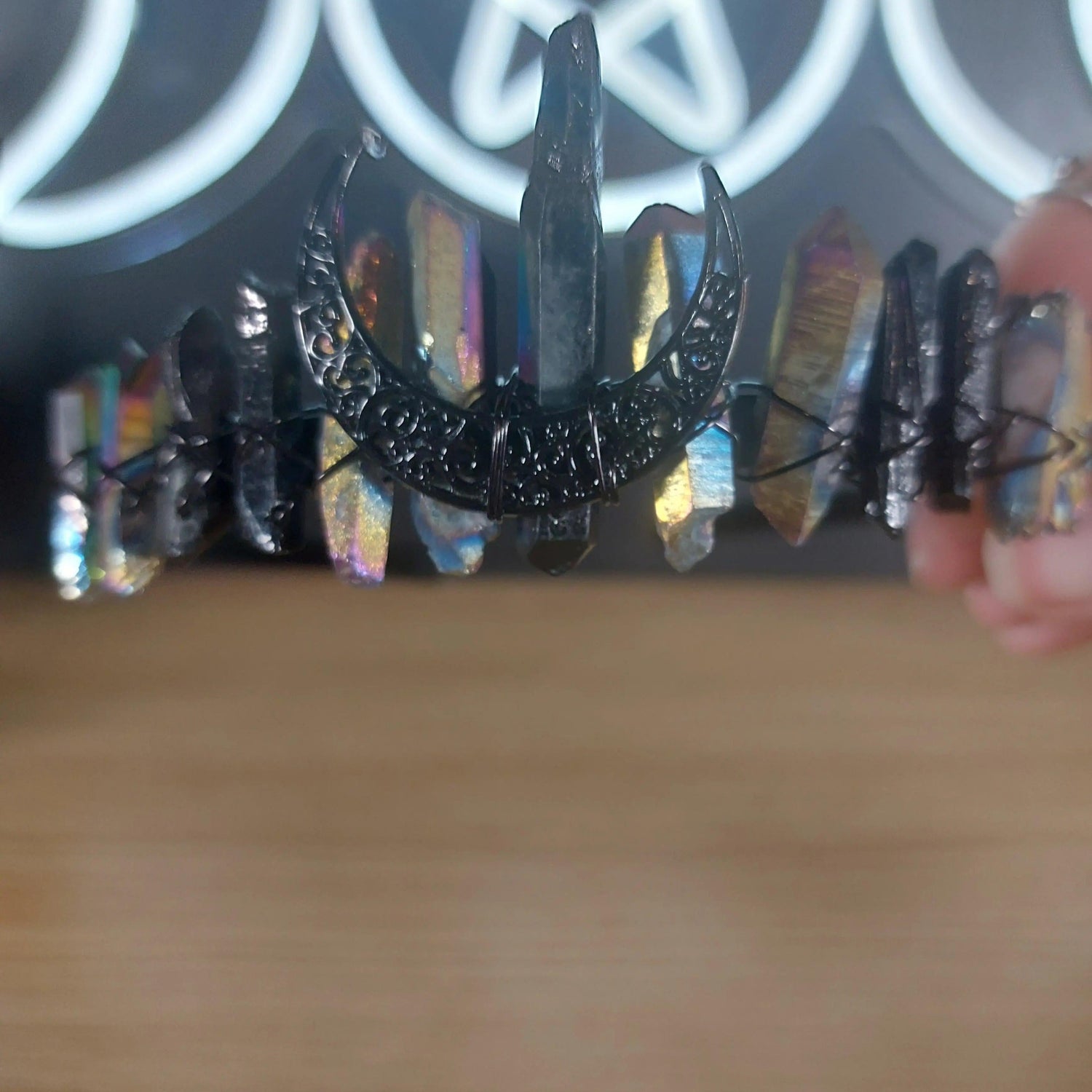 Black and rainbow quartz crystal crown headband with a crescent moon centerpiece.