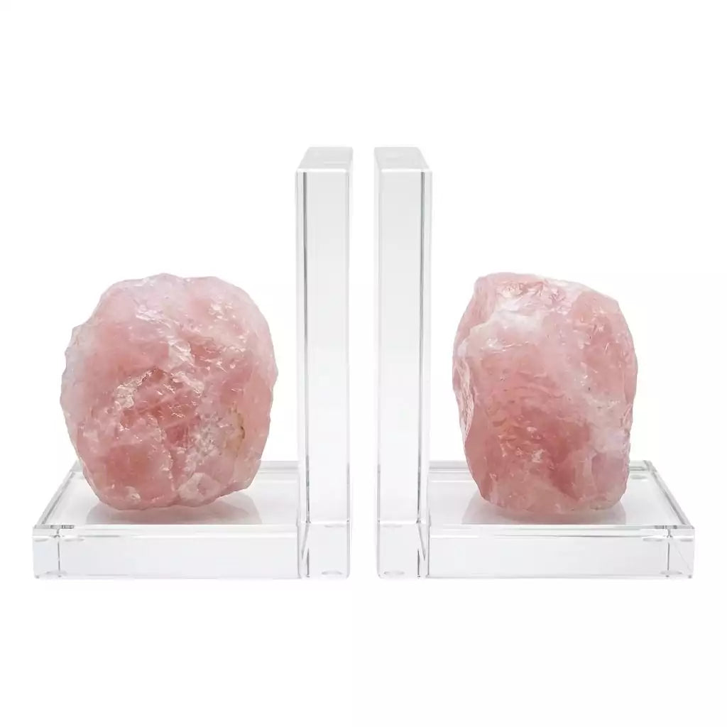 Matched set of two natural rose quartz slab bookends in soft pink with crystalline internal structure, shown propping books on plain surface